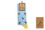 Light blue sock with bee pattern and yellow toe, on a white background with Bartleby branding.
